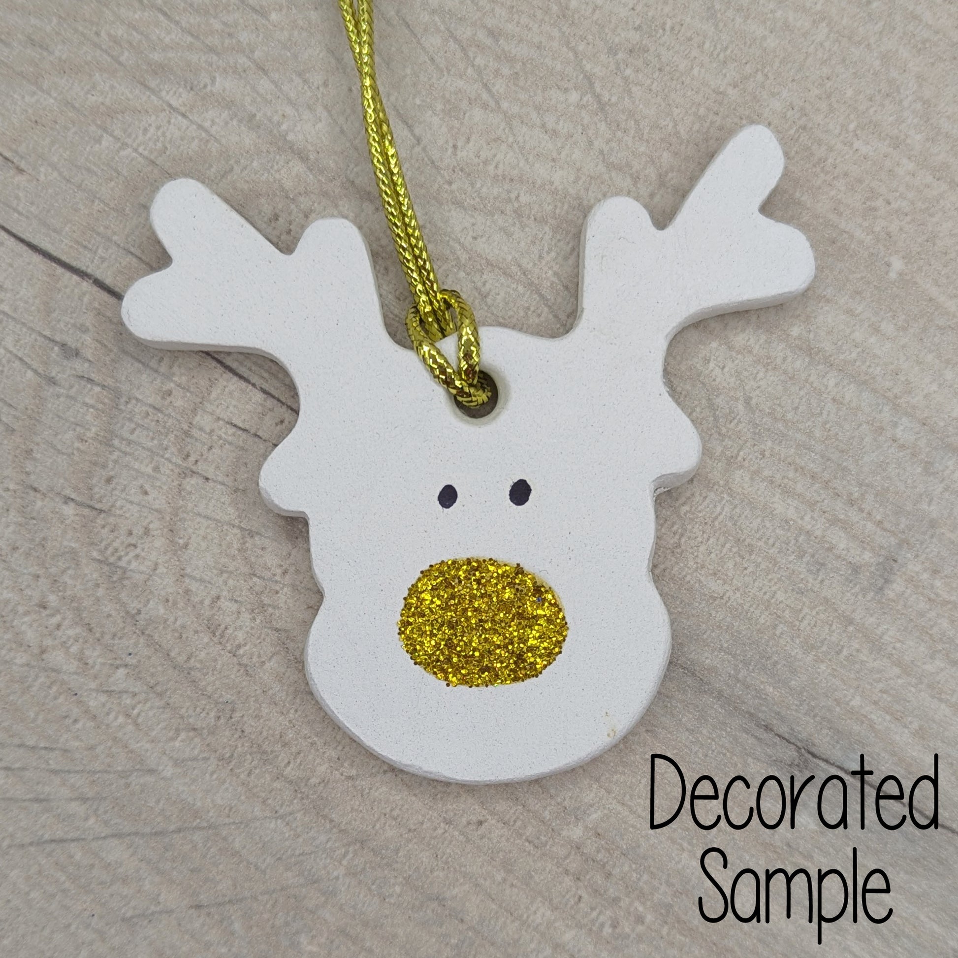 reindeer clay decoration with gold glitter nose and a pair of little black eyes, gold hanging cord