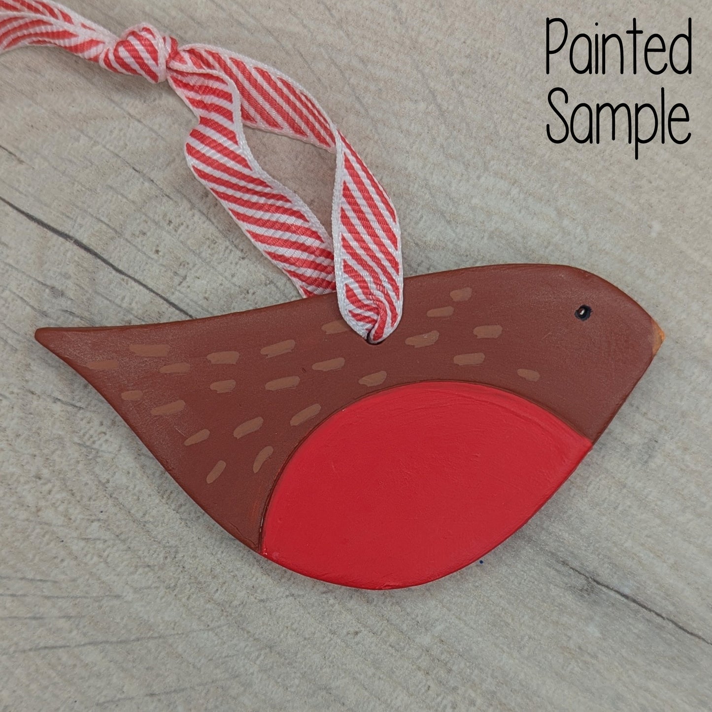 painted clay robin decoration, brown with a red breast, with Christmas candy cain ribbon to hang it
