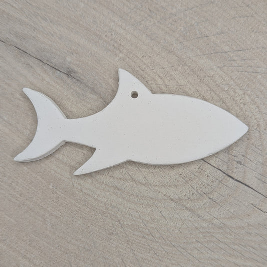 white air dried clay decoration in the shape of a shark