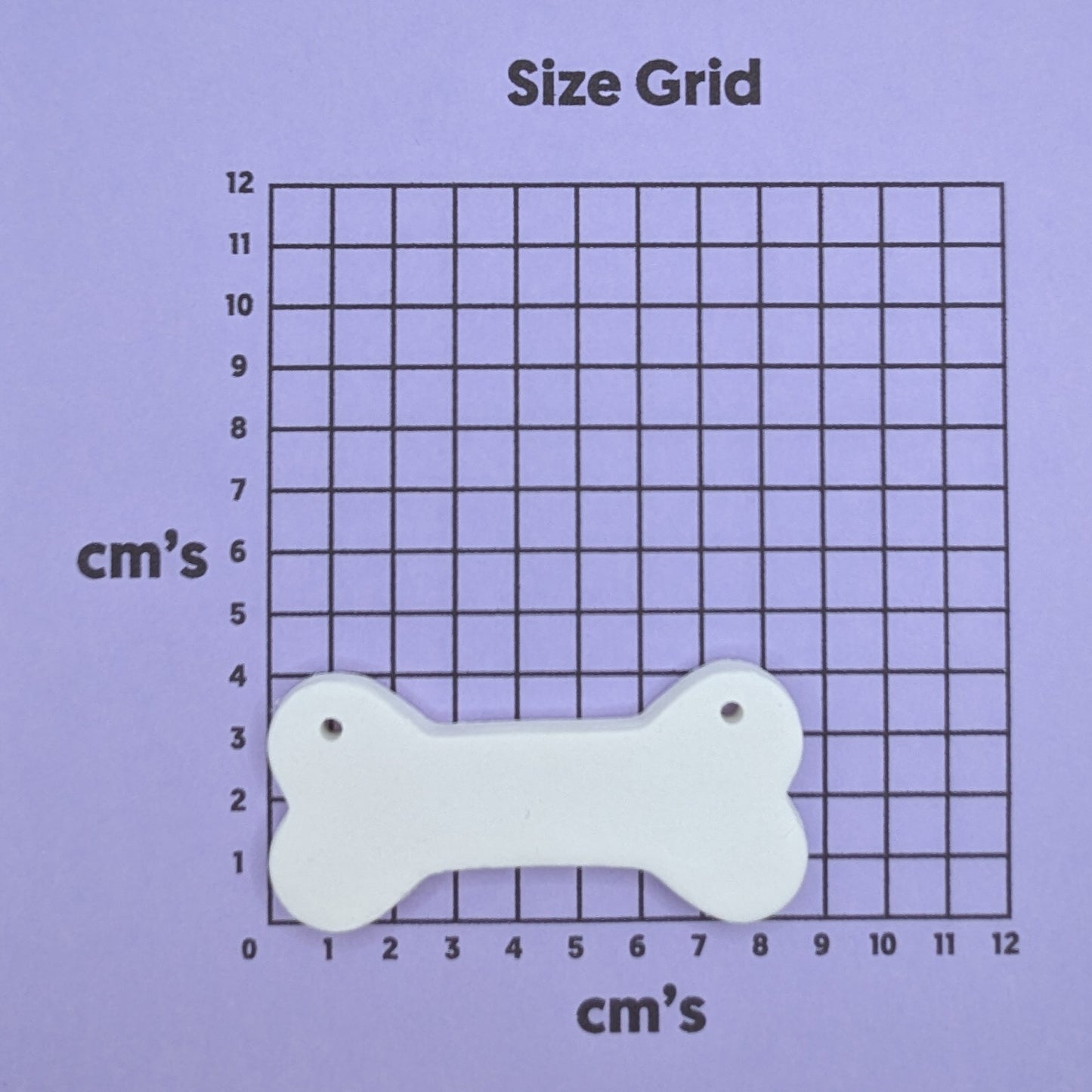 clay bone decoration on a size grid with measurements in centimeters 