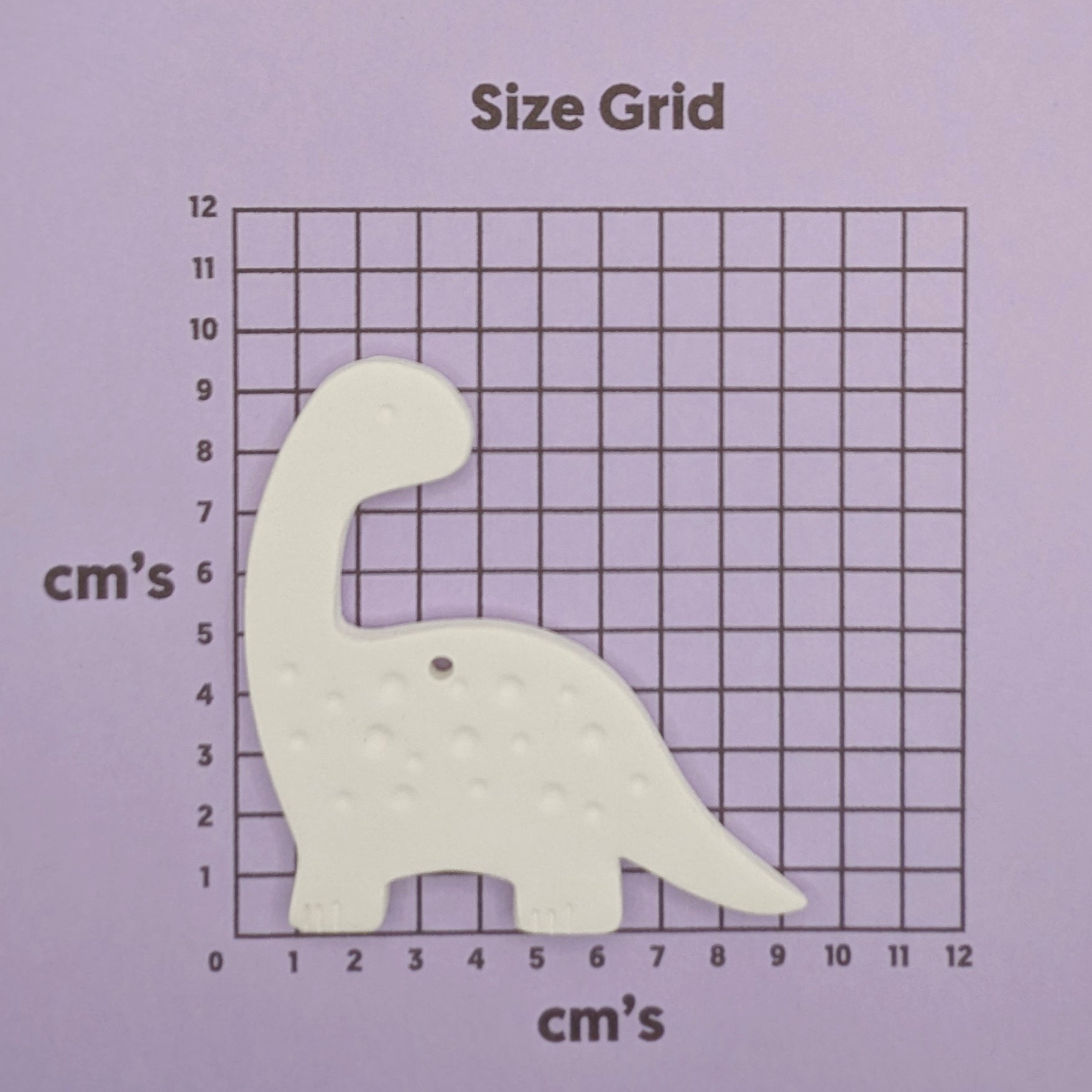 diplodocus Dinosaur-shaped decoration on a size grid with measurements in centimeters on a purple background