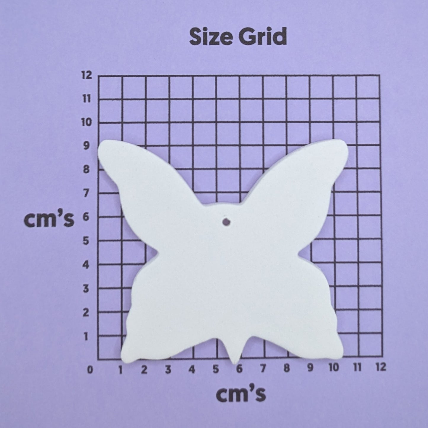clay large butterfly decoration on a size grid with measurements in centimeters 