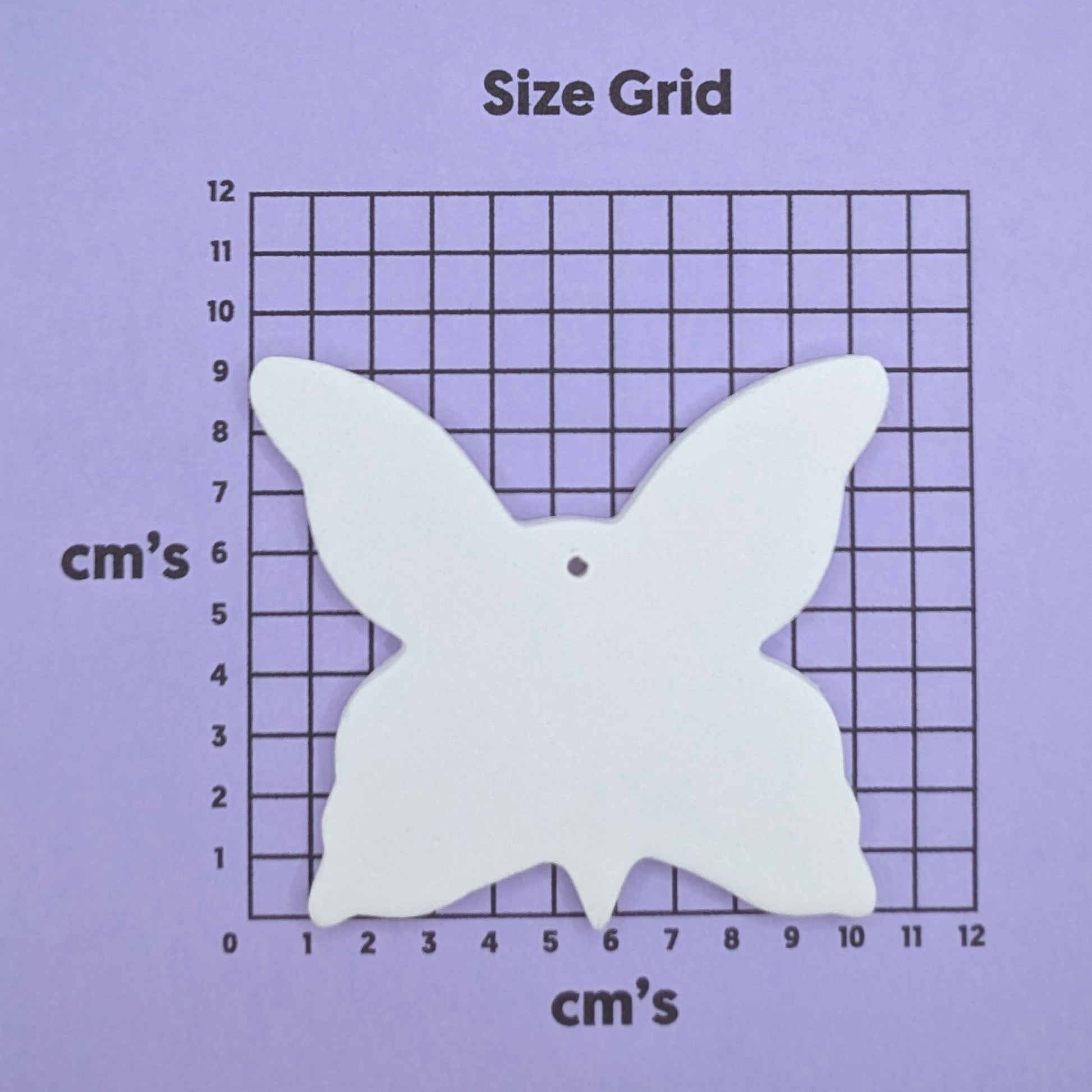 clay large butterfly decoration on a size grid with measurements in centimeters 