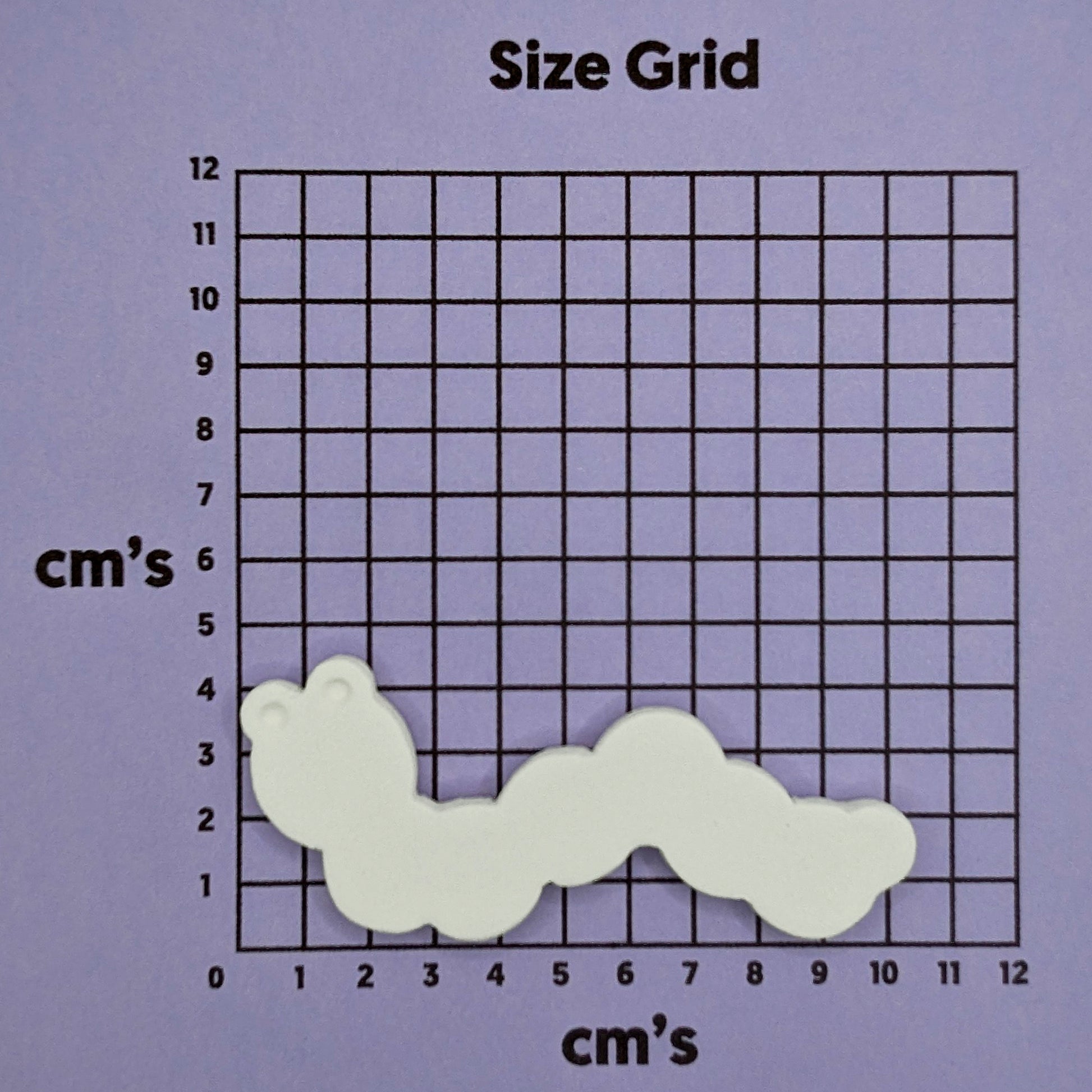 Size grid with a wavy caterpillar decoration on a purple background