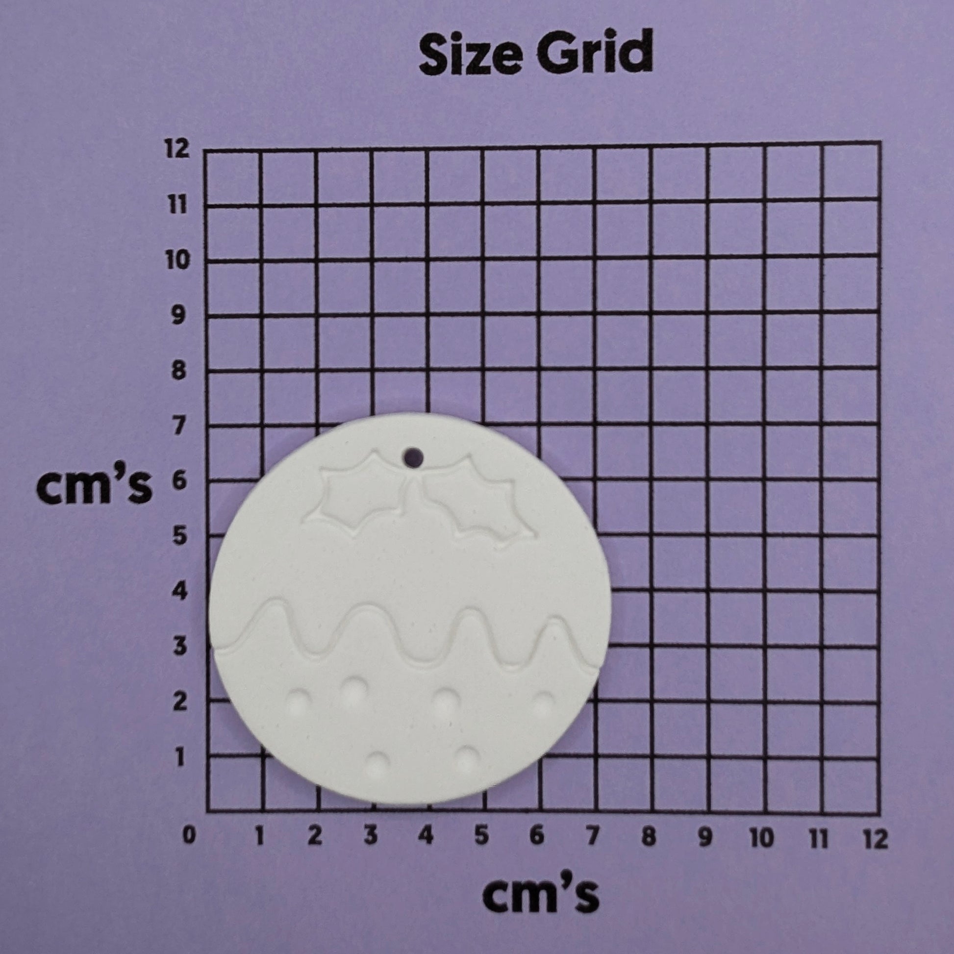 round christmas pudding shaped clay decoration to paint yourself on a purple size cm grid