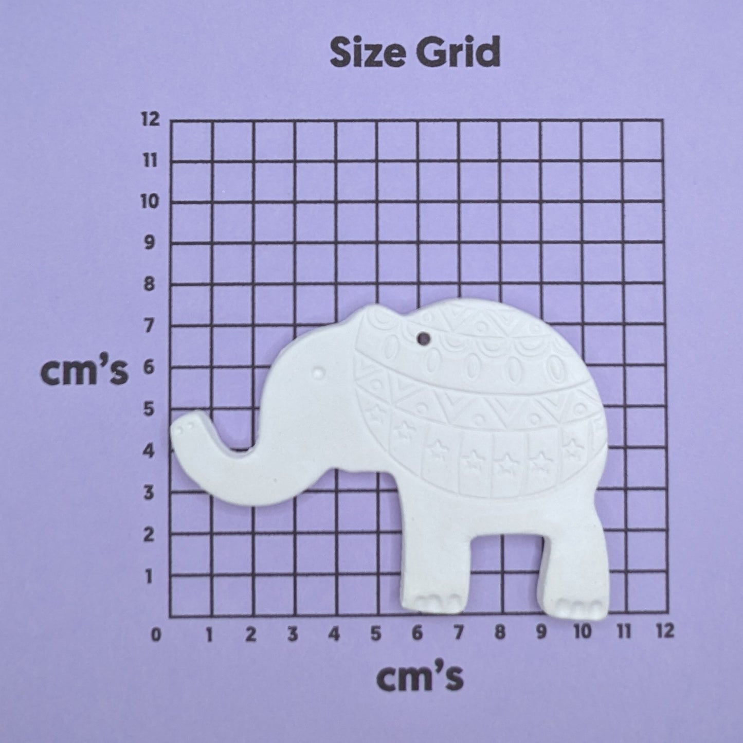 clay elephant decoration on a size grid with measurements in centimeters 