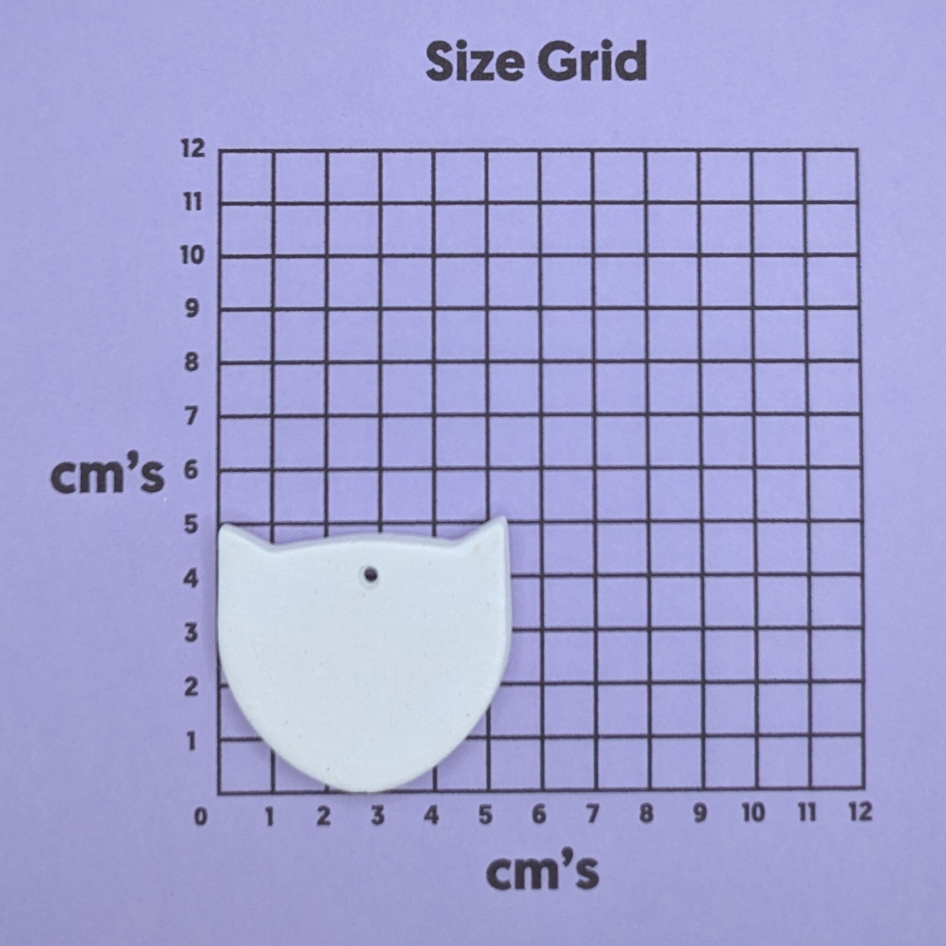 clay fox decoration on a size grid with measurements in centimeters 