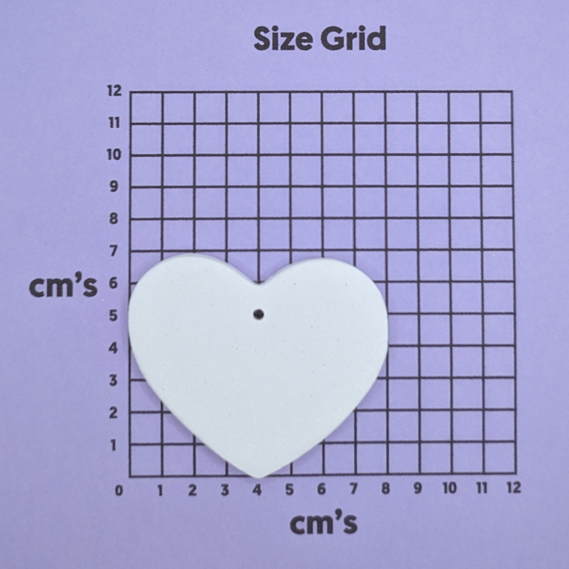 clay heart decoration on a size grid with measurements in centimeters 