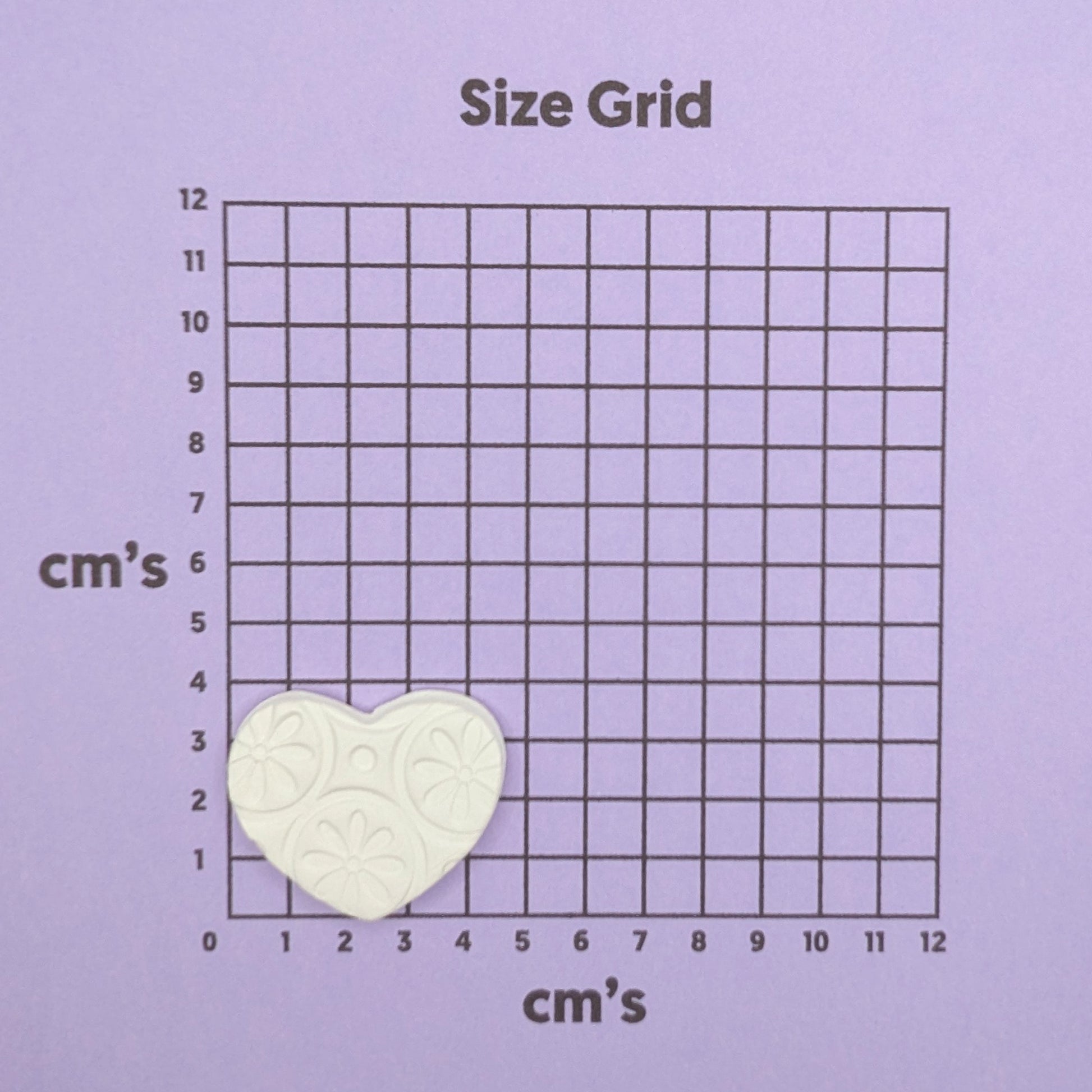 patterned heart clay decoration on size grid
