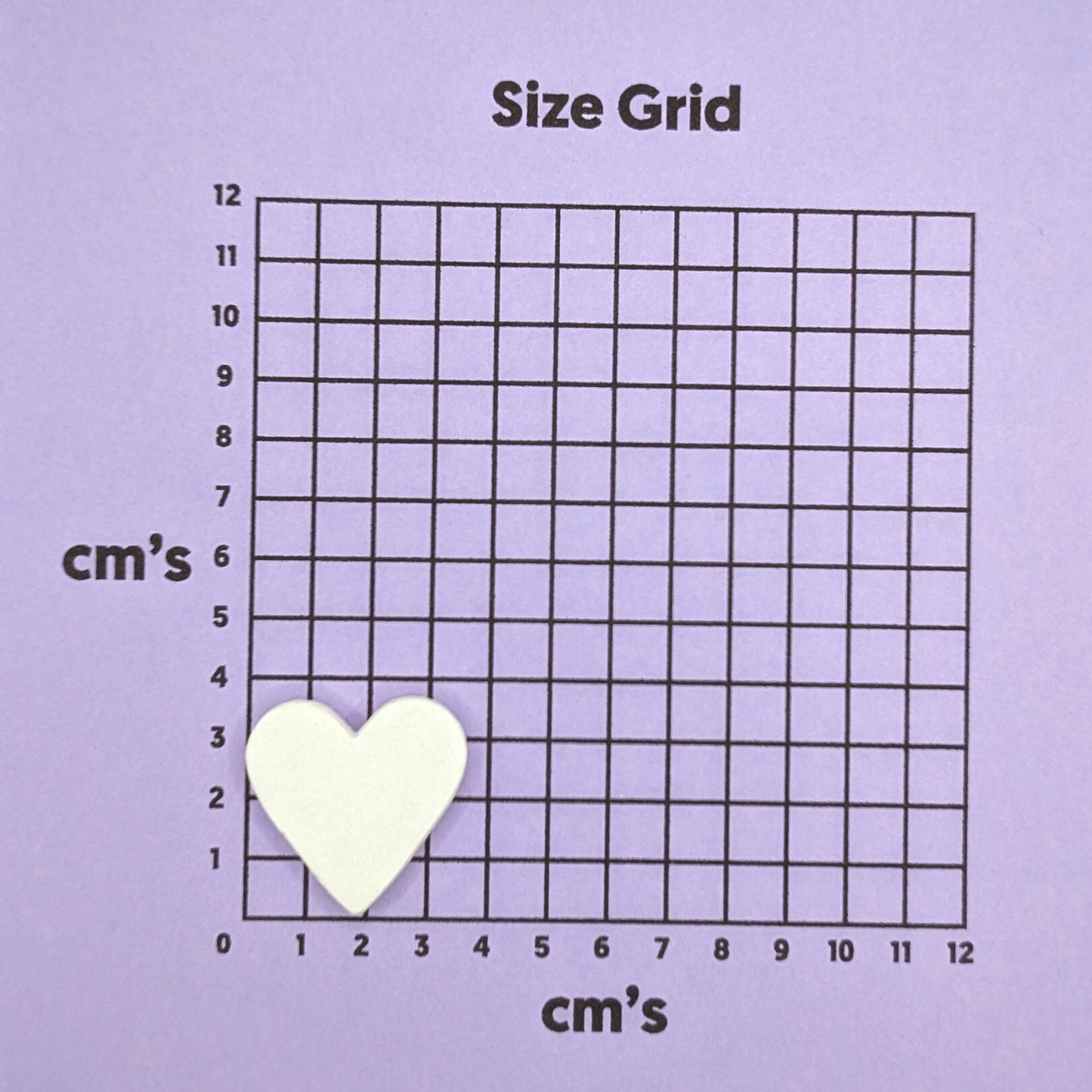 Size grid with a small heart shaped decoration on it