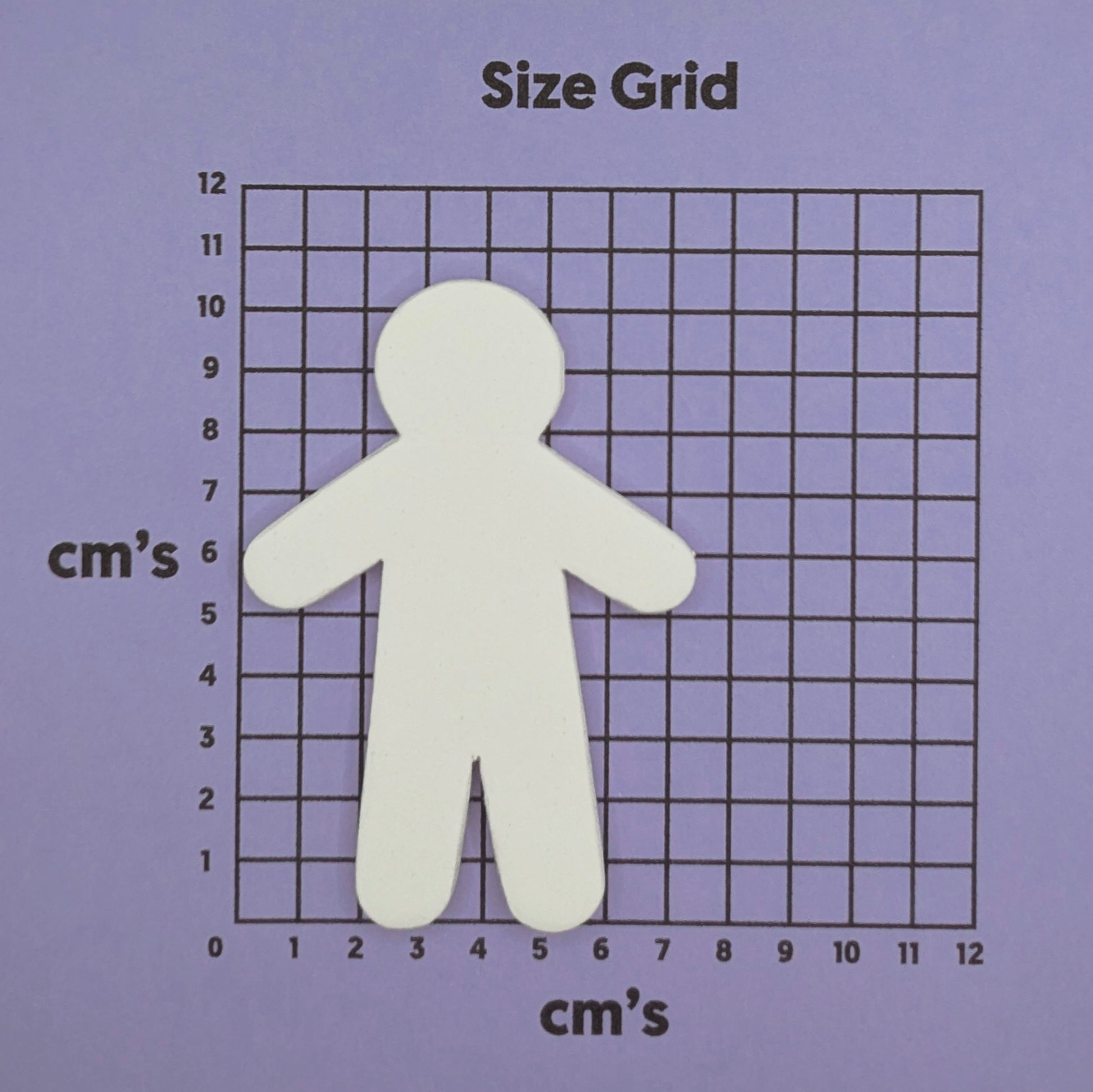 male shaped clay decoration on a size grid with centimeter measurements