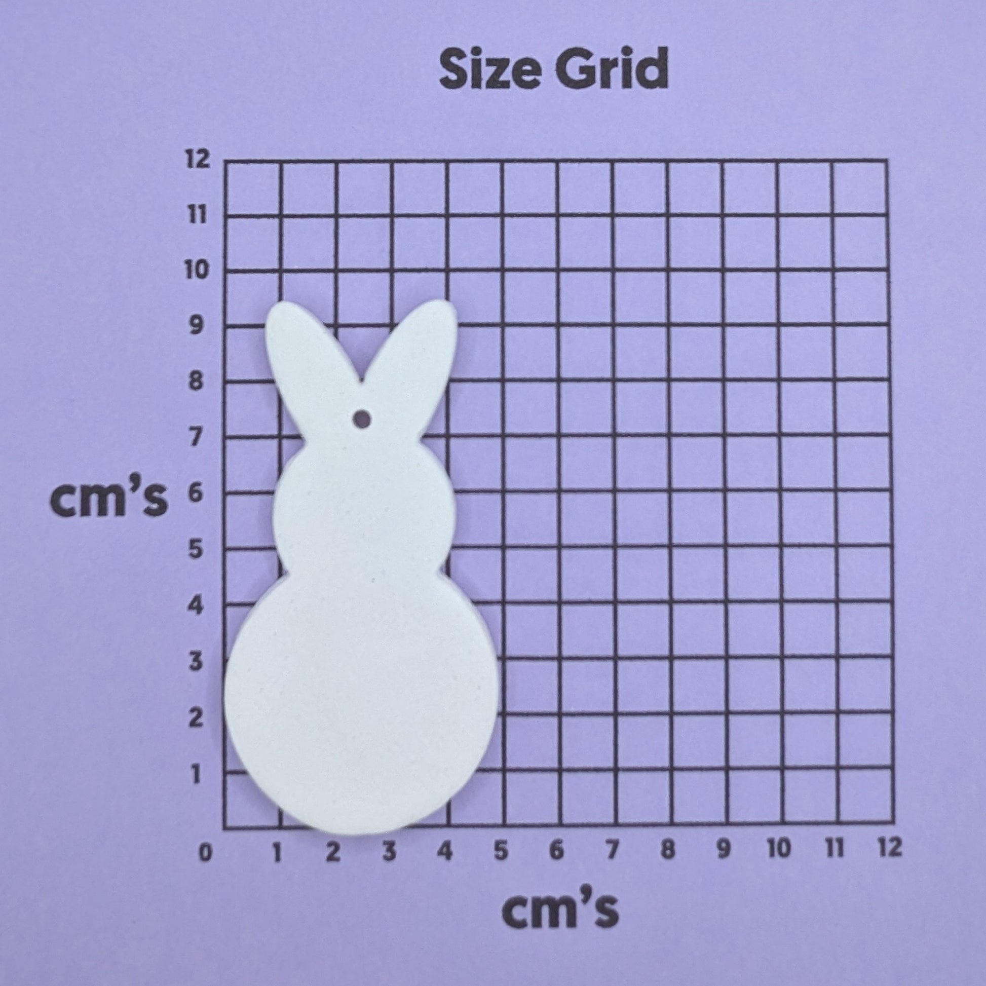 clay round body rabbit decoration on a size grid with measurements in centimeters 
