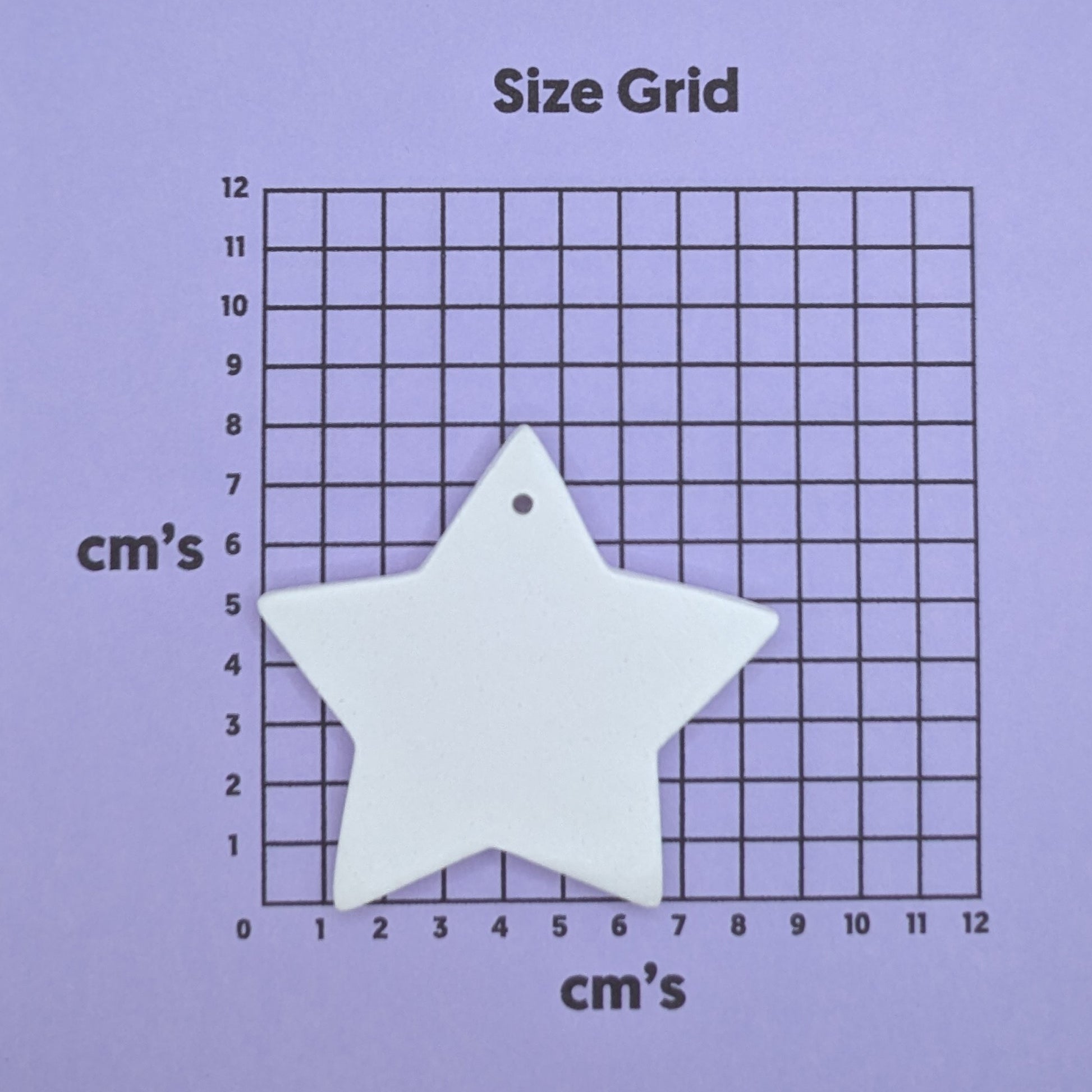 clay star decoration on a size grid with measurements in centimeters 