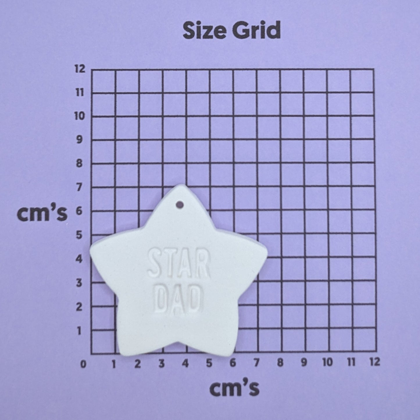 clay star dad decoration on a size grid with measurements in centimeters 