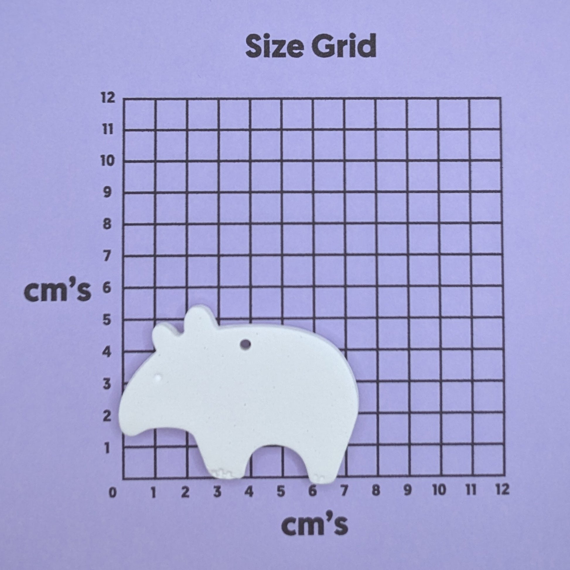 clay tapir decoration on a size grid with measurements in centimeters 