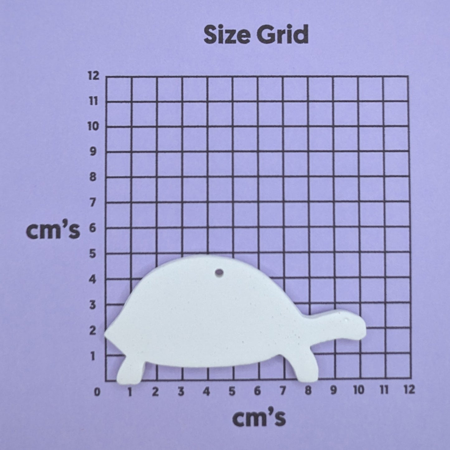 clay tortoise decoration on a size grid with measurements in centimeters 