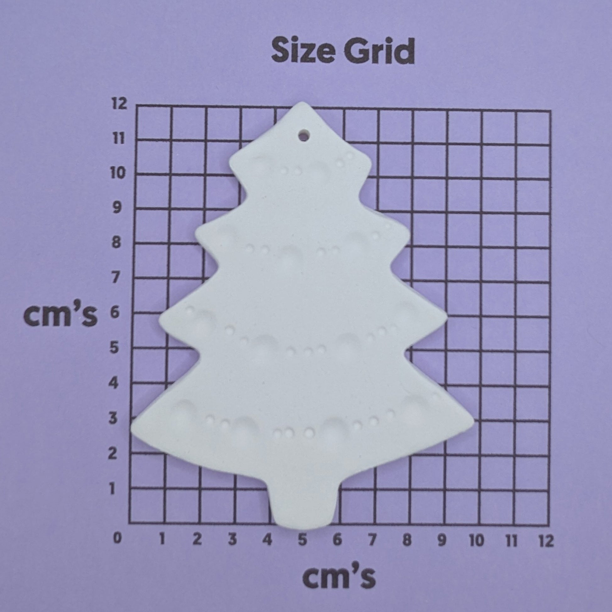 size chart with christmas tree clay decoration on it to show size