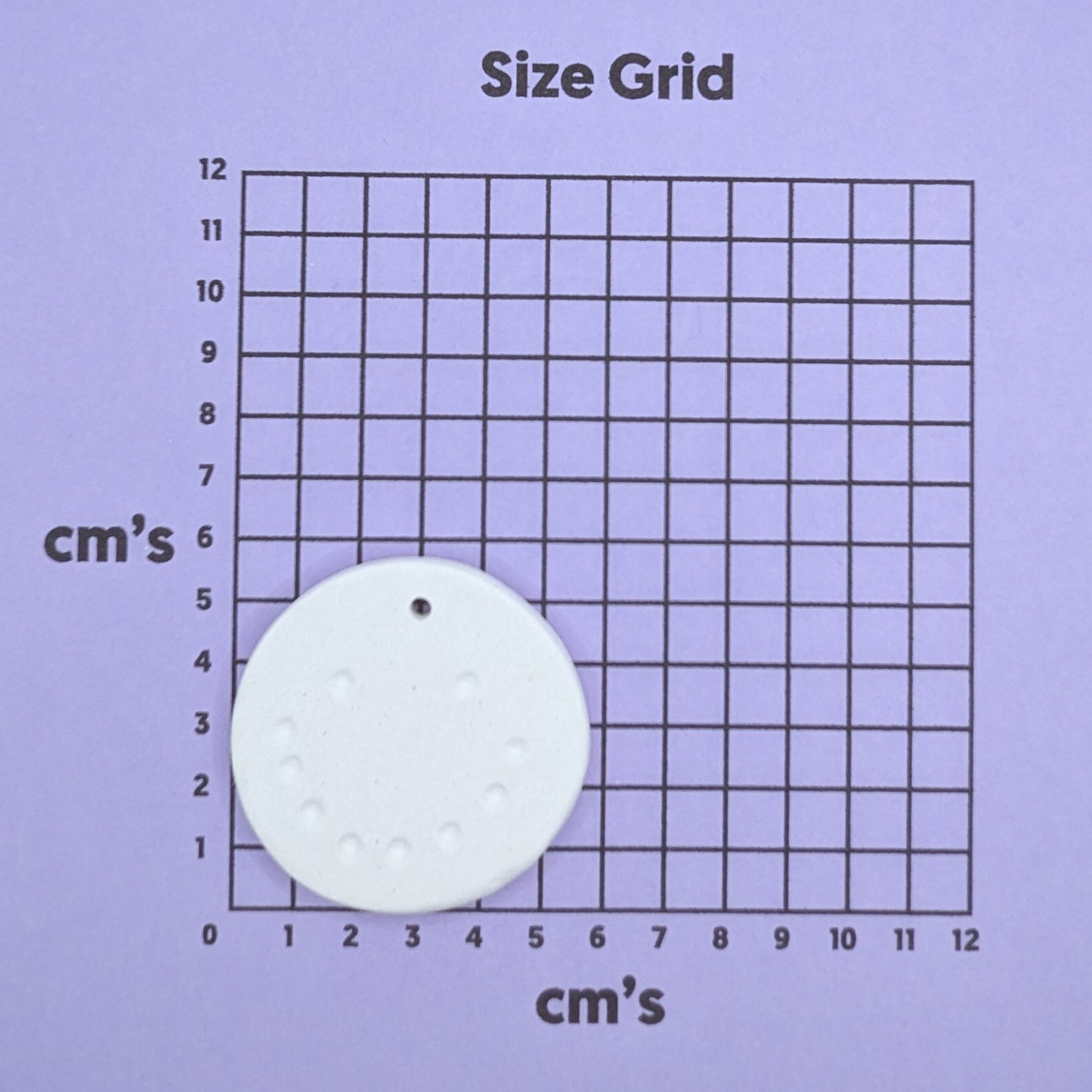 Size grid with a round snowman face decoration on it