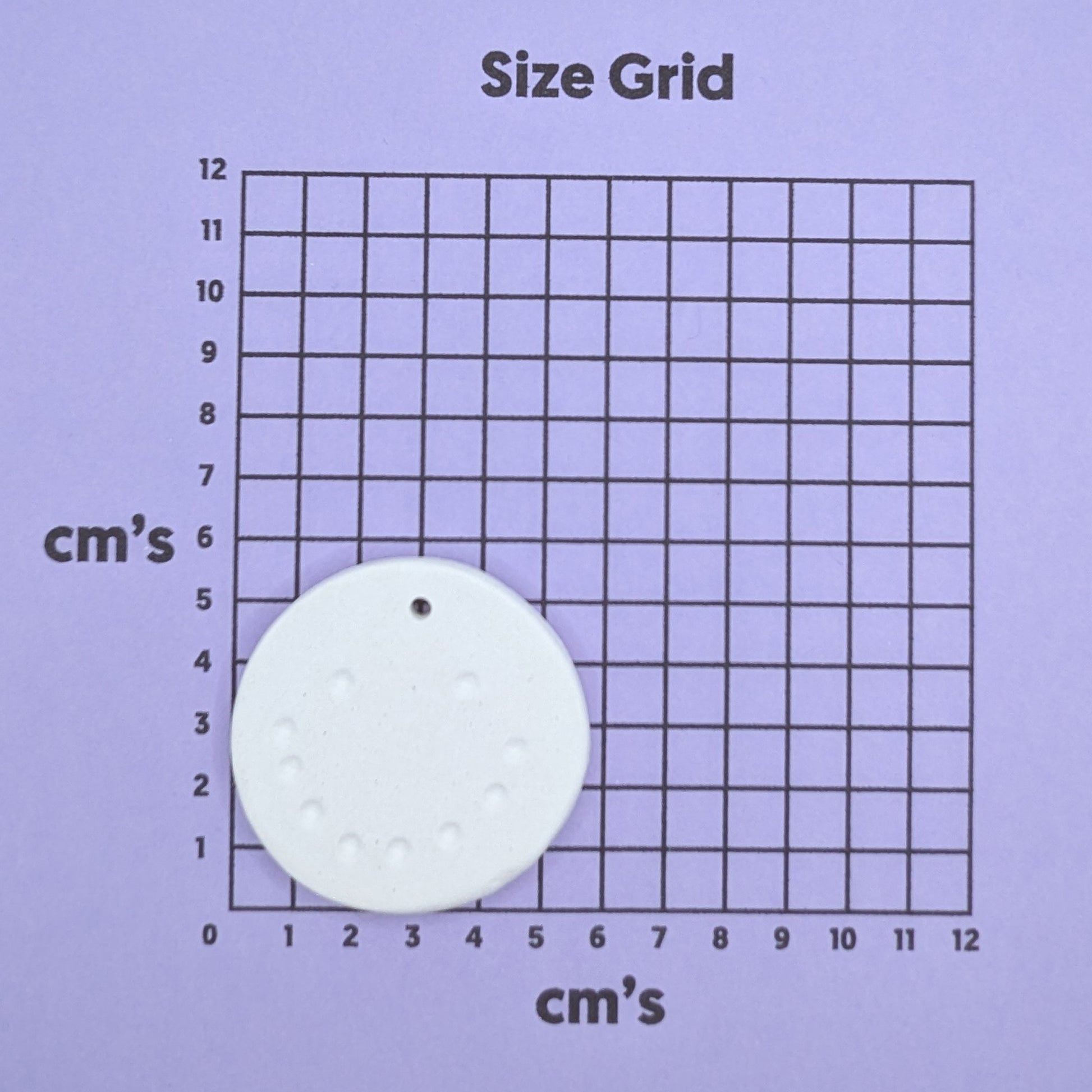 Size grid with a round snowman face decoration on it