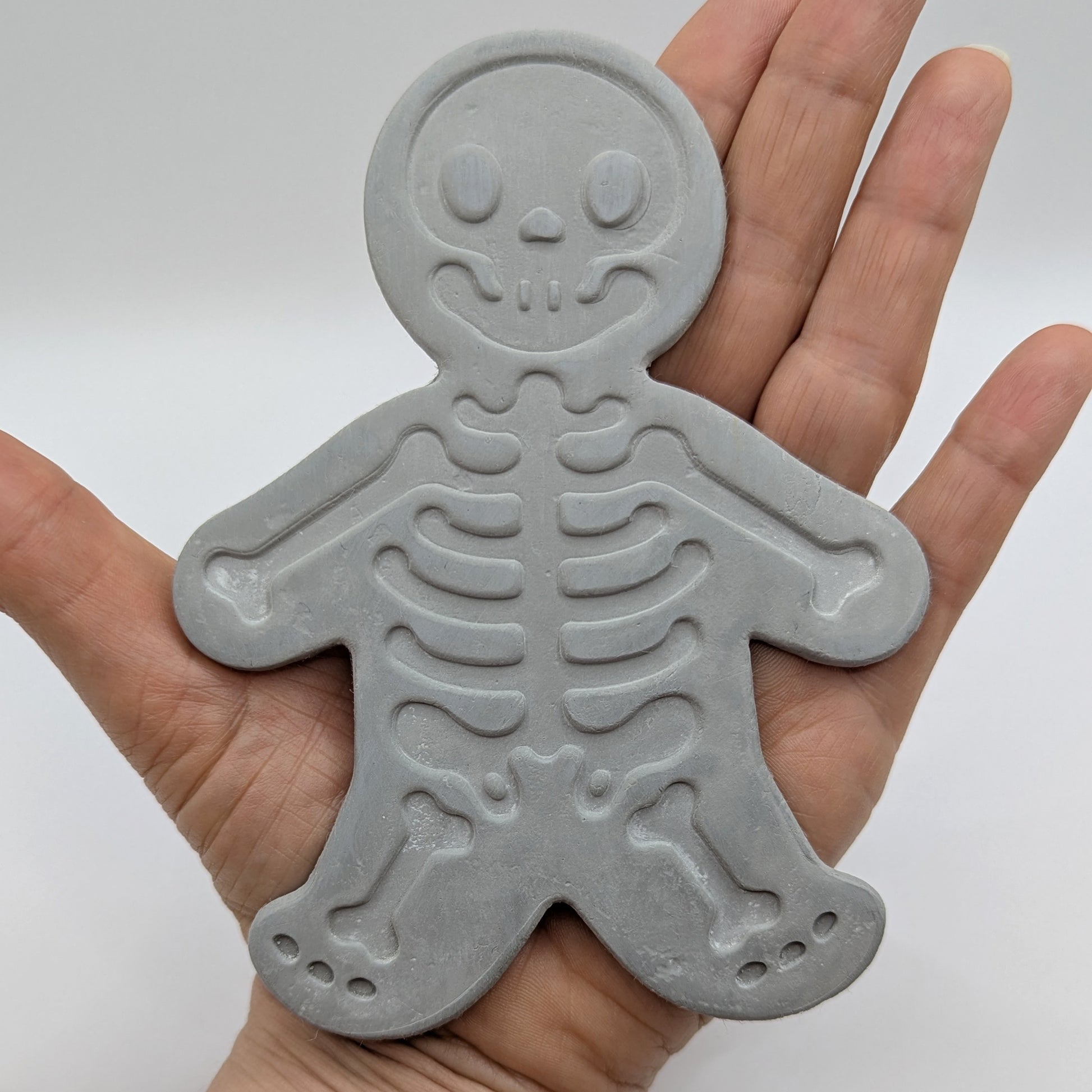 grey air dried clay decoration being held in the palm of a hand, one of my larger decorations