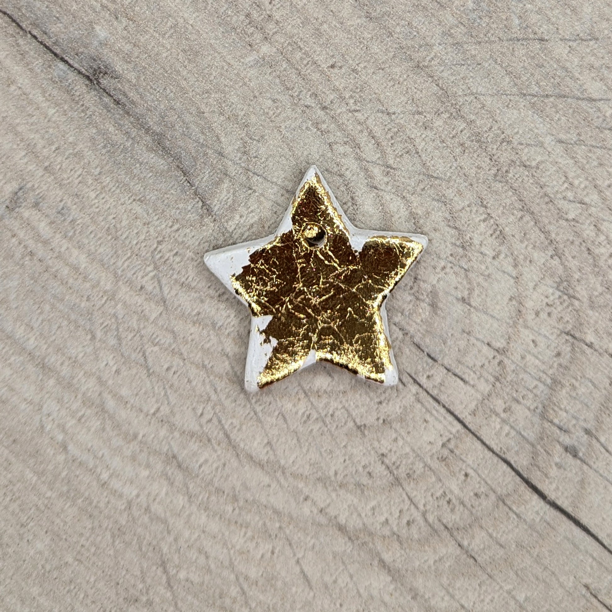 tiny gold foiled, air dried clay star