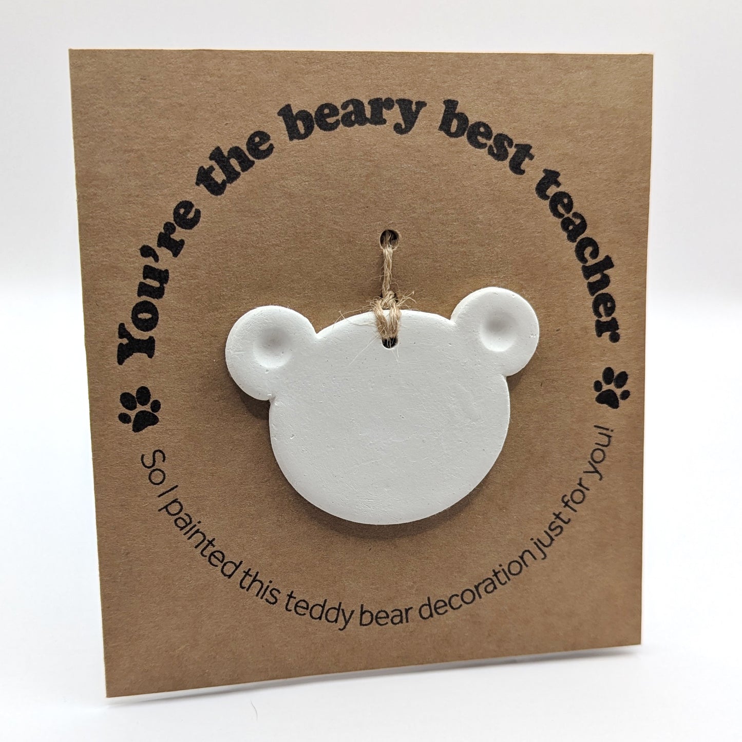 'You're the beary best teacher' text on a brown kraft card with  a clay teddy bear head decoration attached for you to paint and decorate