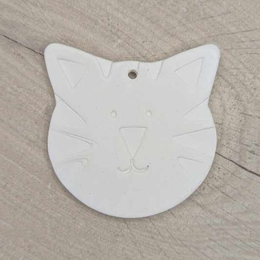 large cat or tiger shaped clay decoration with a tiger face stamped into the clay to help little ones paint it