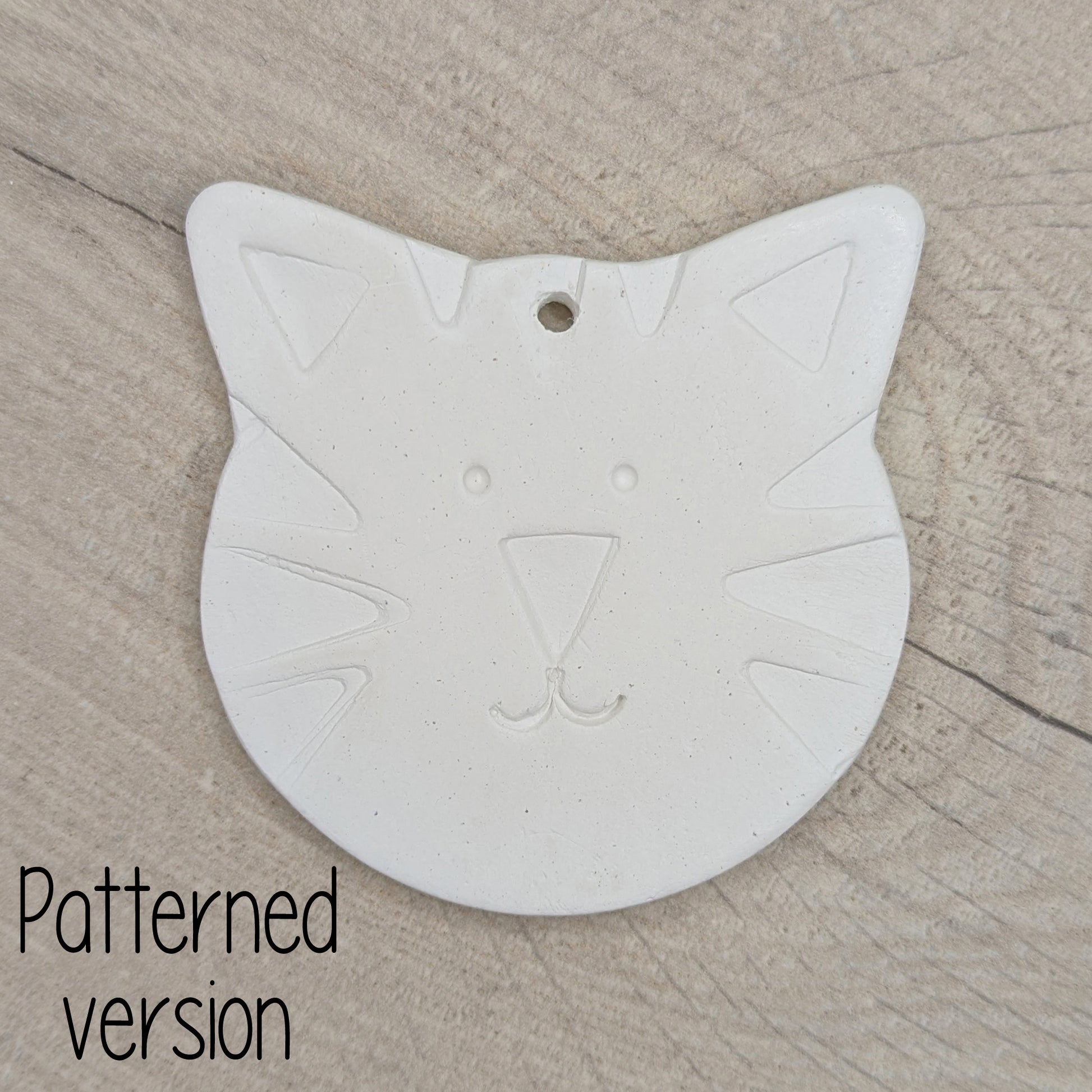 large cat or tiger shaped clay decoration with a tiger face stamped into the clay to help little ones paint it