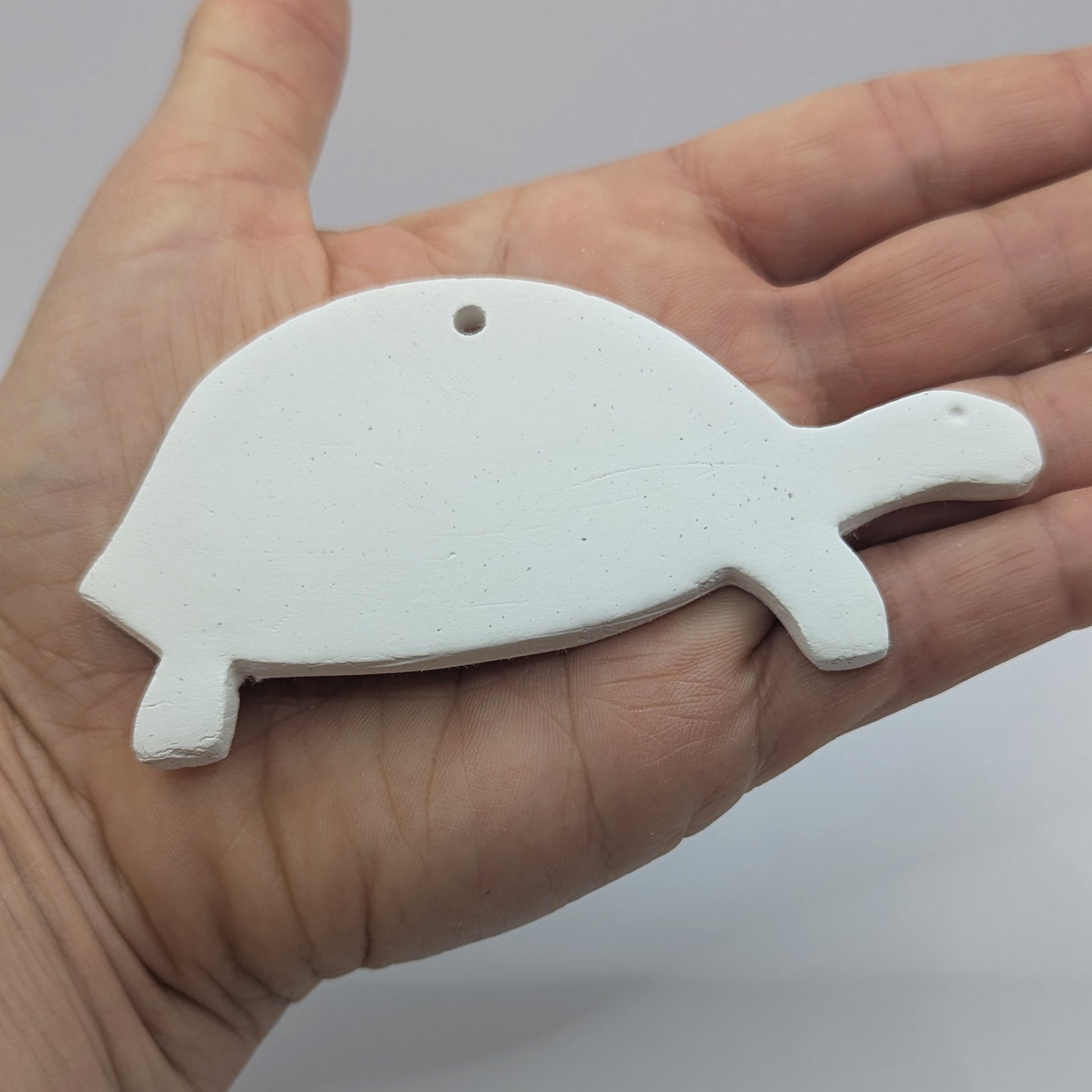 tortoise air dried clay decoration in some ones hand to show size