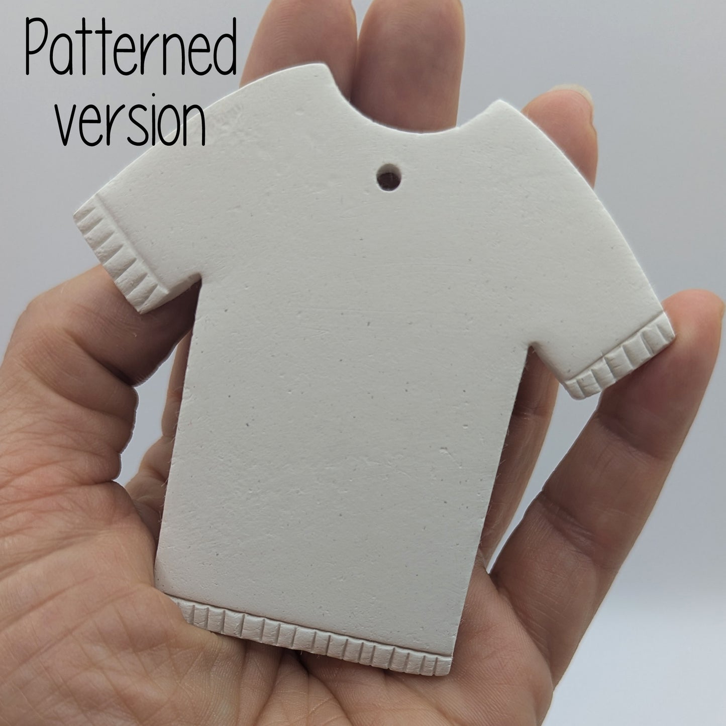 patterned t-shirt decoration made from air dried clayt with detail around the sleeves and bottom of t-shirt