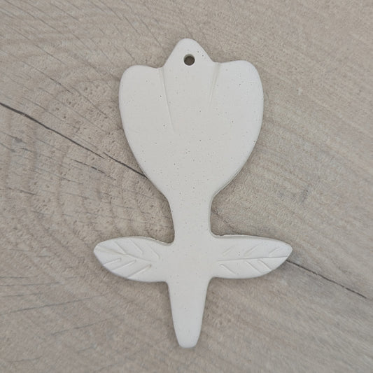 White clay decoration in the shape of a tulip with leaf pattern stamped on