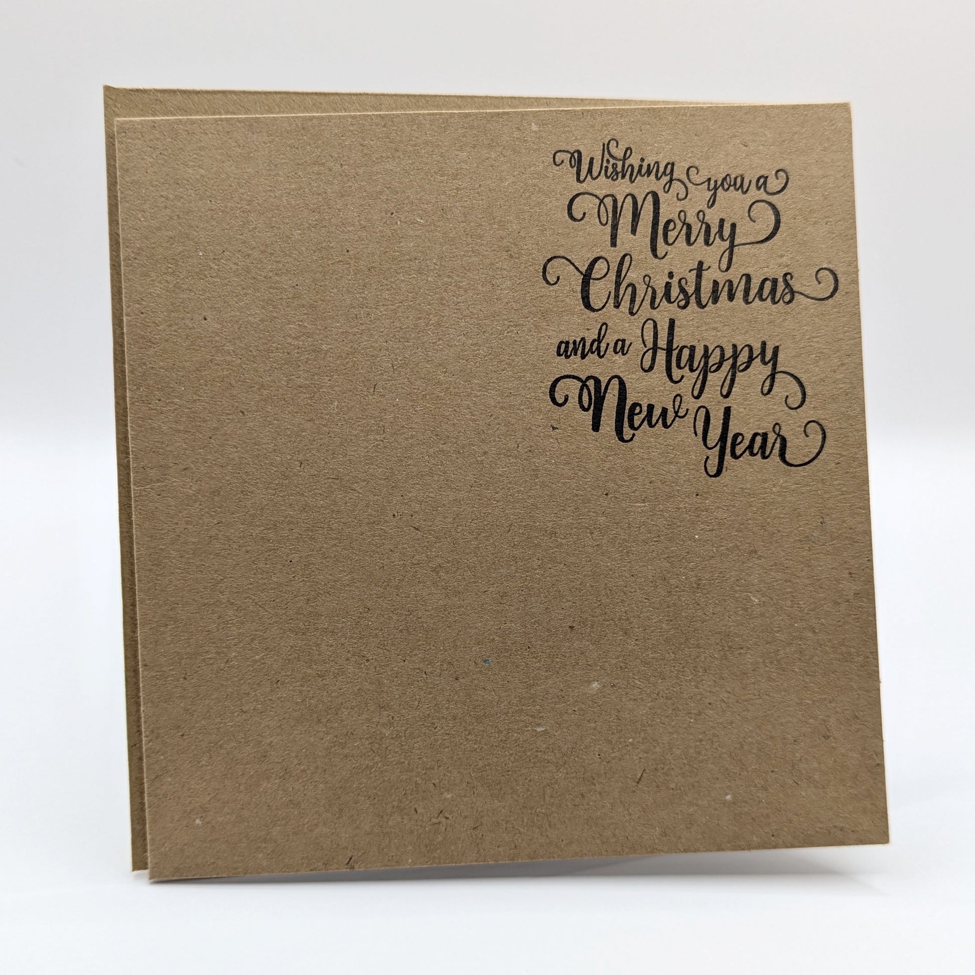 wishing you a merry Christmas and a happy new year, stamped in black ink onto a kraft card, come with matching envelope