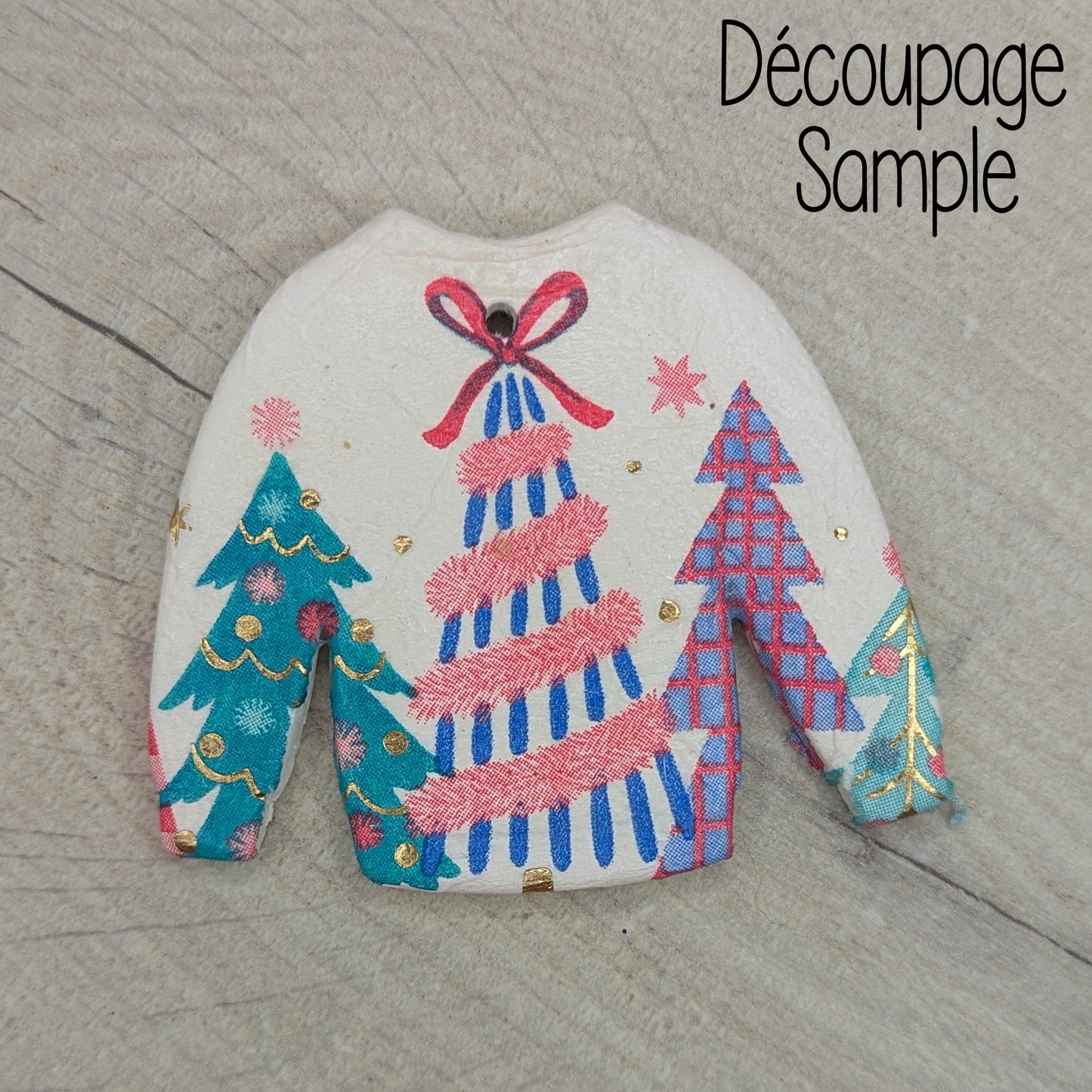 clay jumper decoration, decorated by decoupaging a Christmas themed napkin onto it 