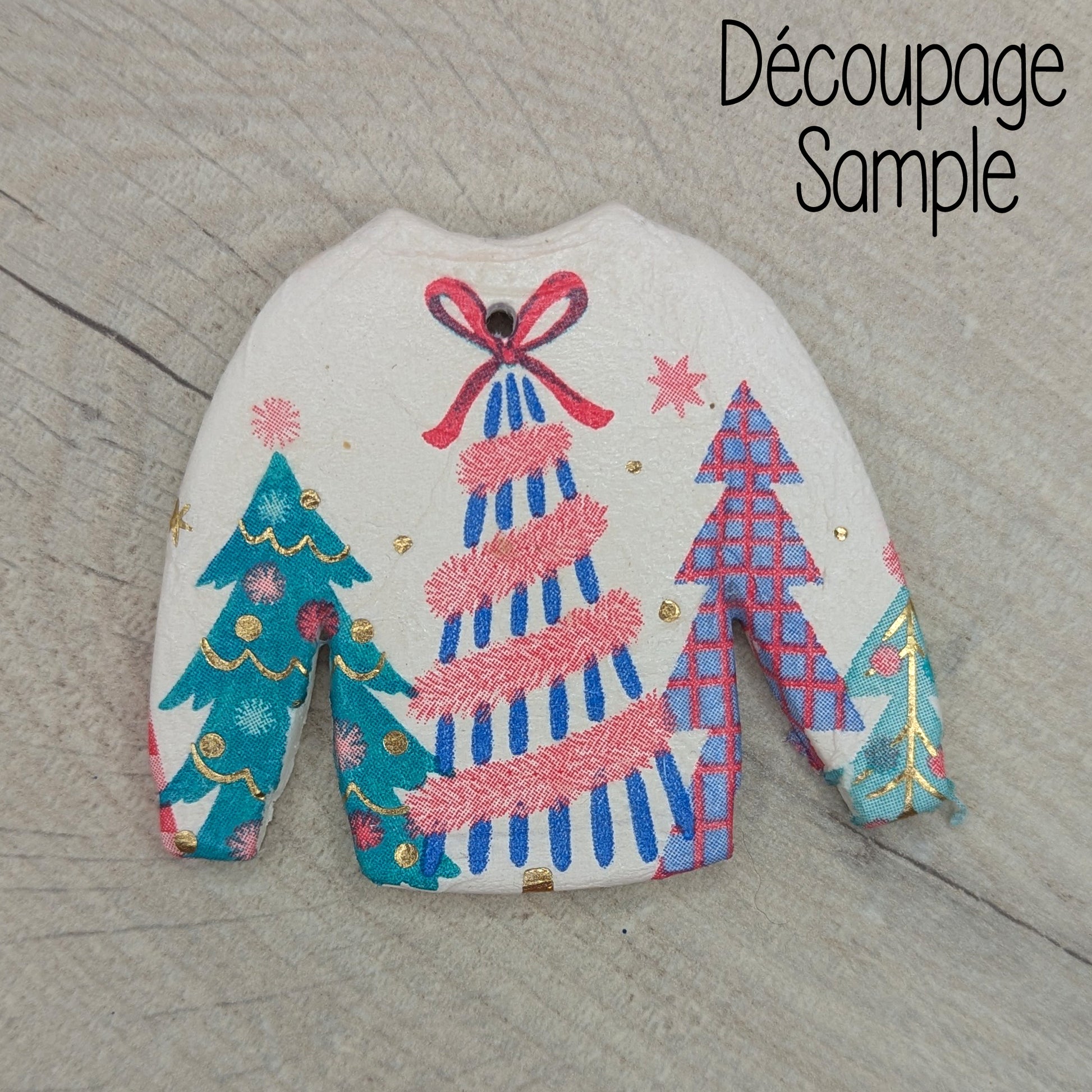 clay jumper decoration, decorated by decoupaging a Christmas themed napkin onto it 