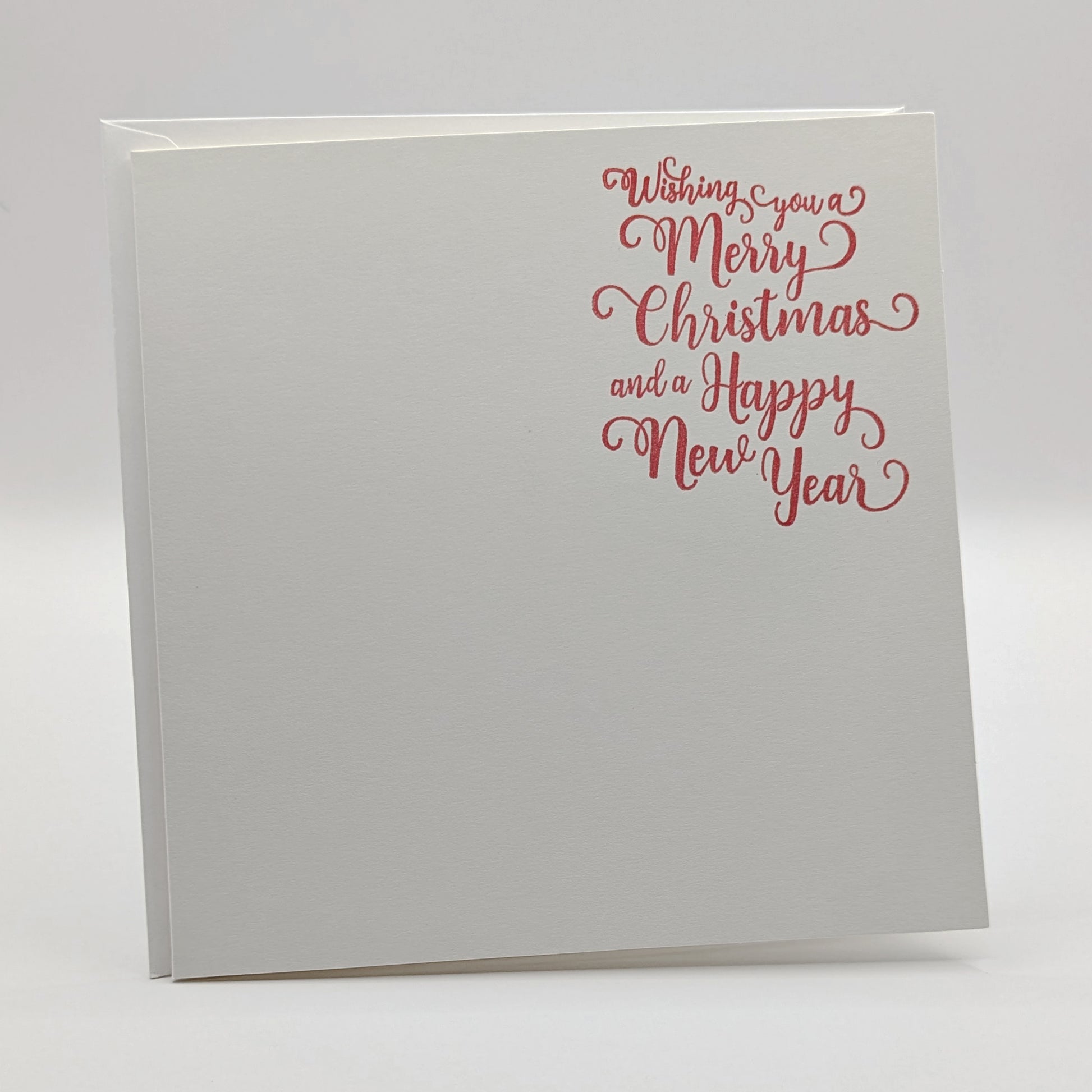 wishing you a merry Christmas and a happy new year, stamped in red ink onto a white card, comes with matching envelope