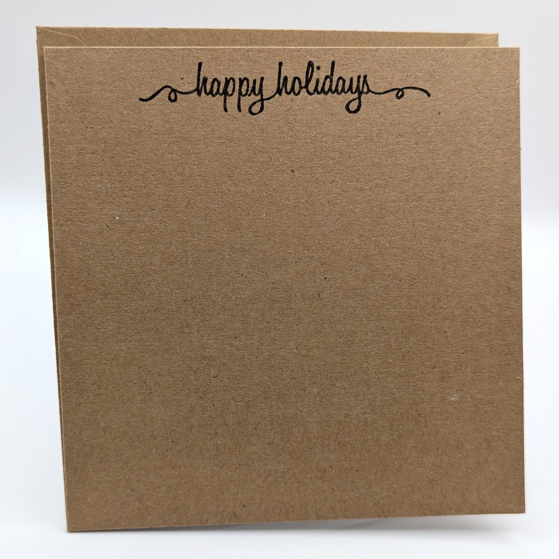 happy holidays stamped in black ink onto a kraft card, comes with envelope