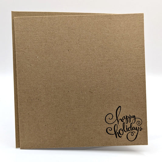 happy holidays stamped in black ink onto a kraft card, comes with envelope
