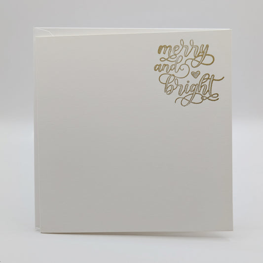 wording 'merry and bright' in a script font, stamped in gold ink onto a white card comes with matching envelope
