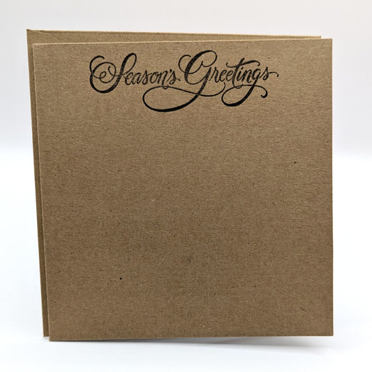 seasons greeting stamped in black ink onto a kraft card, comes with envelope