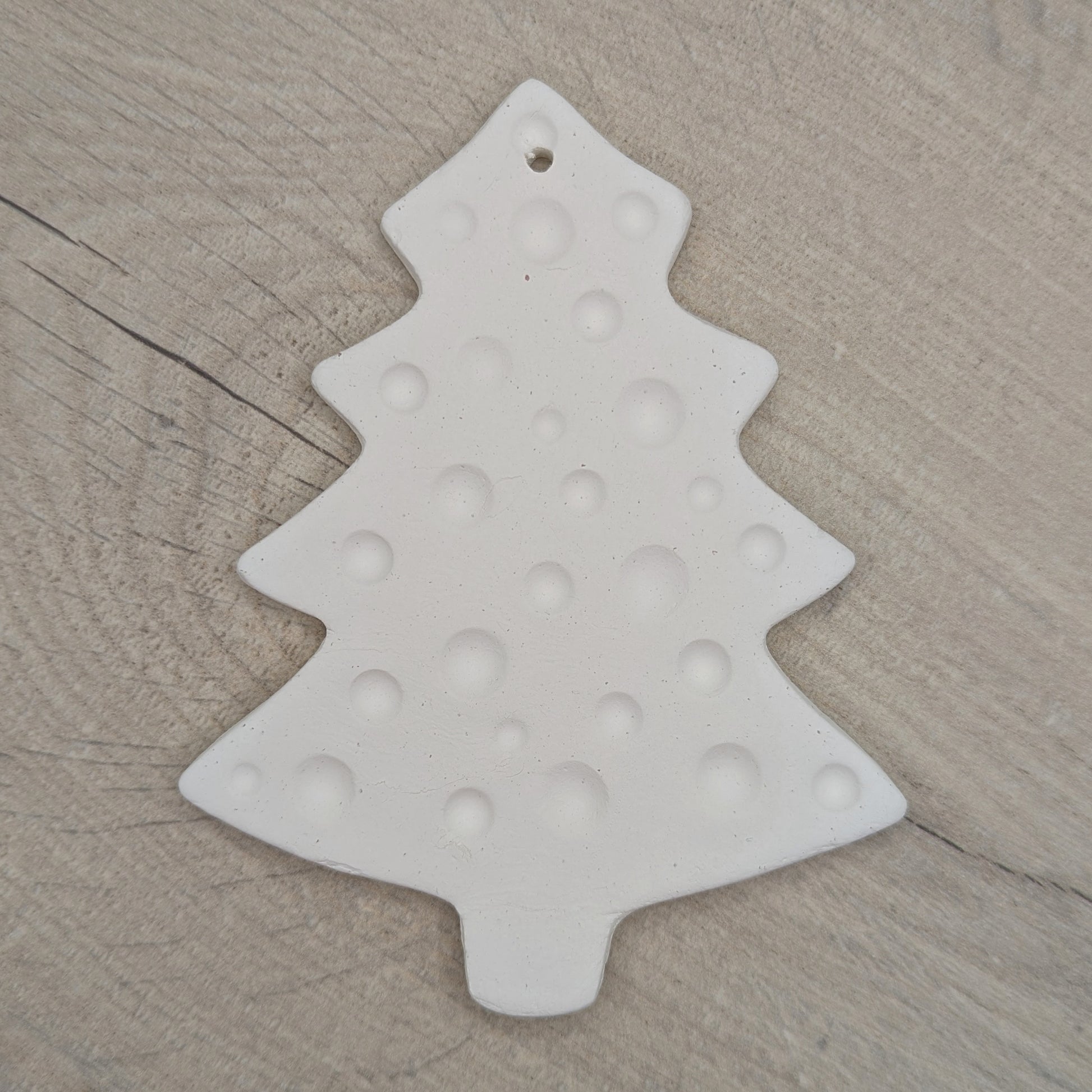 white air dried clay Christmas tree decoration with bauble / spotted pattern stamped into the clay