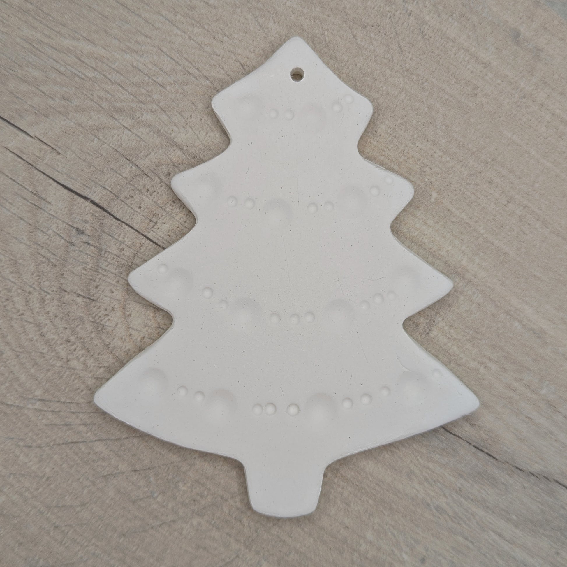 white air dried clay Christmas tree decoration with tinsel pattern stamped into the clay